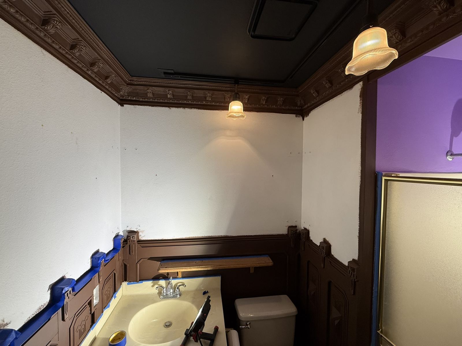 Themed bath with bare white walls and original Victorian panelling, taped for installation